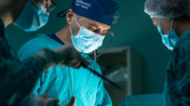 a group of doctors performing surgery in an operating room